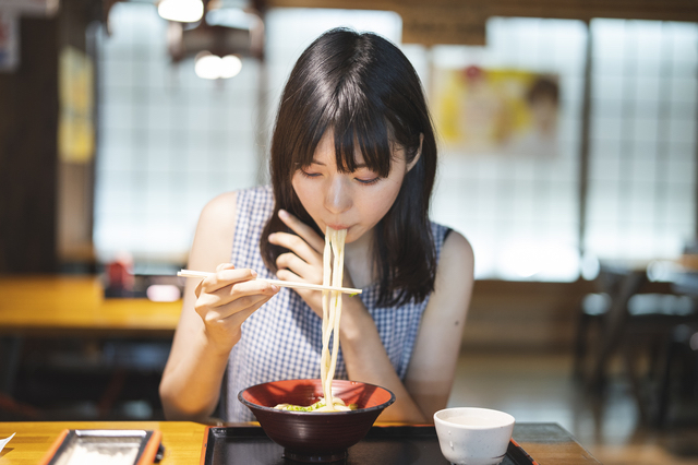 呉でうどんを食べる女性