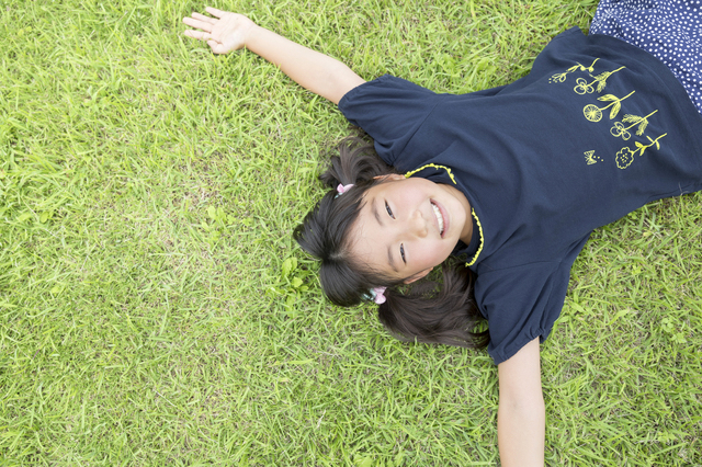 芝生に寝転ぶ小学生